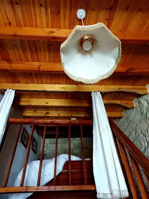 a room with a wooden ceiling with a window at John' s House in Omodos in Limassol