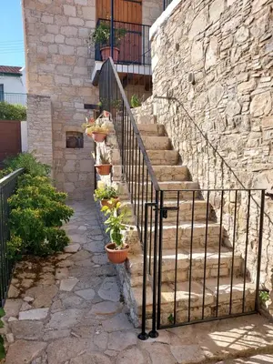 a set of stairs with potted plants on them at John' s House in Omodos in Limassol