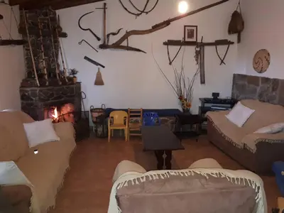 a living room with couches and a fireplace at Agrompelo House in Agros