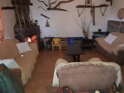 a living room with couches and a fireplace at Agrompelo House in Agros