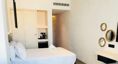a bathroom with a bed and a mirror at Abacus Suites in Ayia Napa