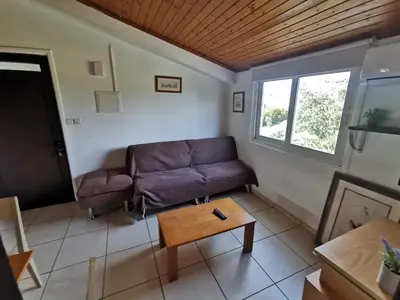 a living room with a couch and a table at Strovolos rooms Studios in Nicosia