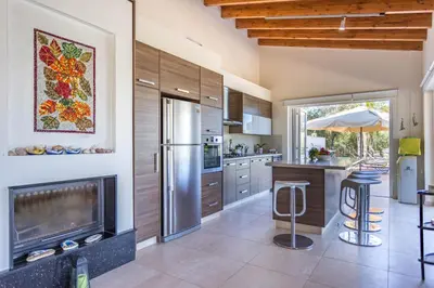 a kitchen with a stainless steel refrigerator and a fireplace at Marina Estate in Protaras