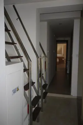 a staircase in a building with a metal railing at Marina Estate in Protaras