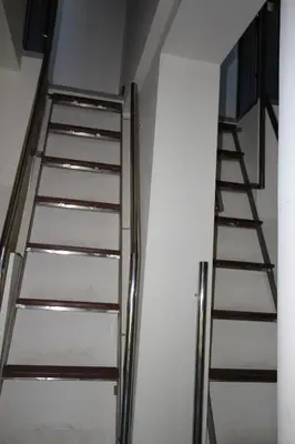 a set of metal stairs in a white room at Marina Estate in Protaras