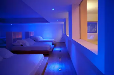 a living room with two beds and blue lights at Sandy Beach Hotel & Spa - ex Sentido in Larnaka