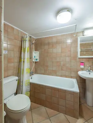 a bathroom with a toilet and a tub and a sink at Themis House in Lemithou