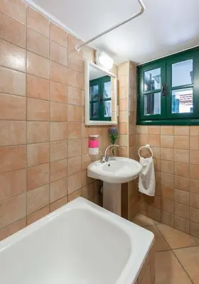 a bathroom with a tub and a sink at Themis House in Lemithou