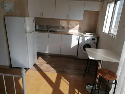 a kitchen with a refrigerator and a washing machine at MIKIS's SeaGate Studio Aprt. in Larnaka