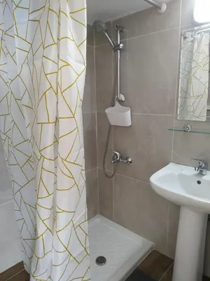 a bathroom with a shower curtain and a sink at MIKIS's SeaGate Studio Aprt. in Larnaka