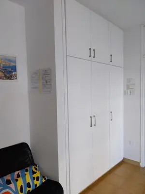 a living room with white cabinets and a couch at MIKIS's SeaGate Studio Aprt. in Larnaka