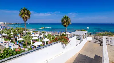 a view of the beach from the balcony of a resort at Sunrise Bay Villa #1 in Paralimni