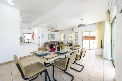 a dining room and living room with a table and chairs at Sunrise Bay Villa #1 in Paralimni