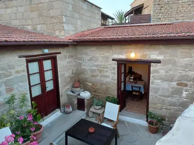 a patio of a house with a table and chairs at Niovi House in Tochni
