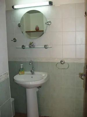 a bathroom with a sink and a mirror at Niovi House in Tochni