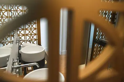 a bathroom with four sinks and a mirror at S Paul City Hotel in Limassol