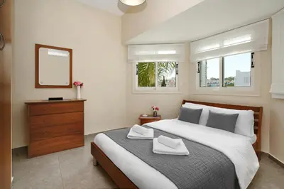 a bedroom with a bed with two towels on it at Villa Venus in Protaras