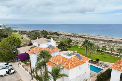an aerial view of a house and the beach at Villa Venus in Protaras