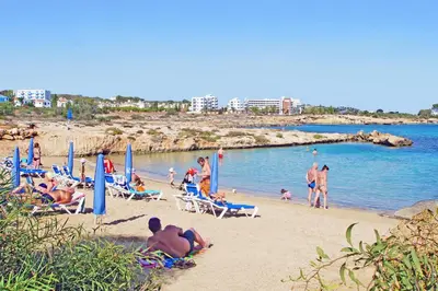 a group of people sitting on a beach at Villa Venus in Protaras
