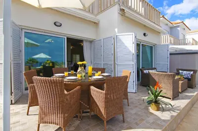 a patio with a table and chairs on a patio at Villa Venus in Protaras
