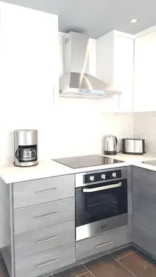 a kitchen with a stainless steel oven and appliances at Dezo Luxury town Apartment in Larnaka
