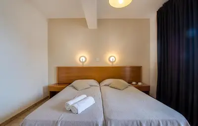 a bedroom with two towels on a bed at Captain Karas Holidays Apartments in Protaras