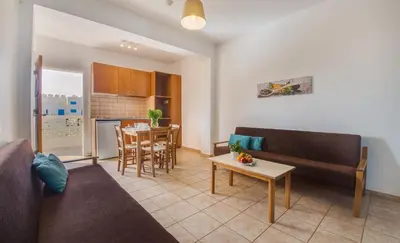 a living room with a couch and a table at Captain Karas Holidays Apartments in Protaras
