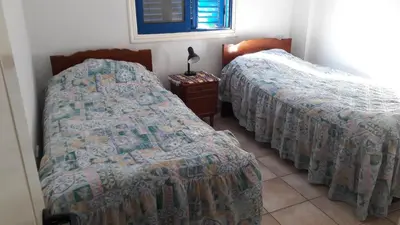 two beds sitting next to each other in a room at Rita SeaView Apartment in Pervolia