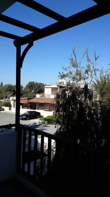 a balcony with a view of a parking lot at Rita SeaView Apartment in Pervolia