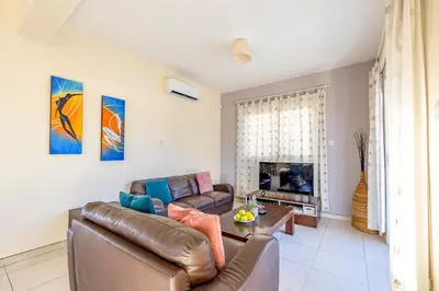 a living room with a couch and a table at Villa Stephania in Ayia Napa