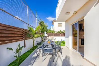 a patio with a table and chairs at Villa Stephania in Ayia Napa