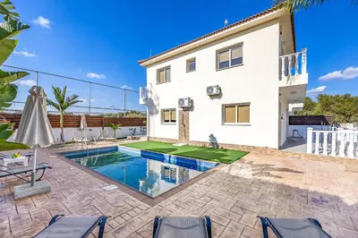 a villa with a swimming pool and a house at Villa Stephania in Ayia Napa