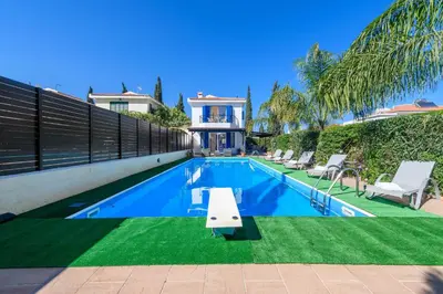 a swimming pool in the backyard of a house at Villa Penelope in Protaras