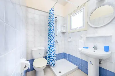 a bathroom with a toilet and a sink at Villa Penelope in Protaras