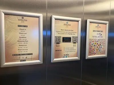 three framed signs on a wall in a elevator at Sveltos Hotel in Larnaka