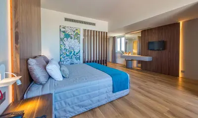 a hotel room with a bed and a television at Sun Hall Hotel in Larnaka