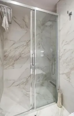 a shower with a glass door in a bathroom at Sun Hall Hotel in Larnaka