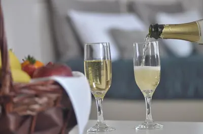 two glasses of white wine being poured at Sun Hall Hotel in Larnaka