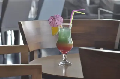 a drink in a glass sitting on a table at Sun Hall Hotel in Larnaka