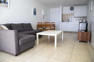 a living room with a couch and a table at Sun Hall Beach Hotel Apartments in Larnaka