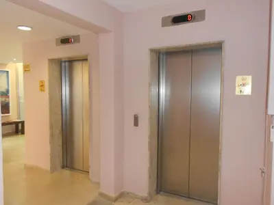 a row of elevators in a building at Sun Hall Beach Hotel Apartments in Larnaka