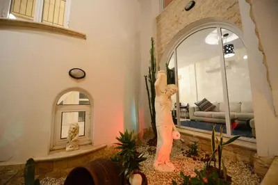 a statue of a man with his arm up in a living room at Karythia in Pyla