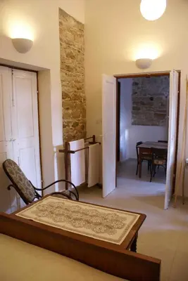 a room with a bed and a dining room with a table at Yiayia's House Limassol city in Limassol