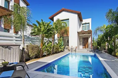 a swimming pool in front of a house at Villa Maris in Protaras
