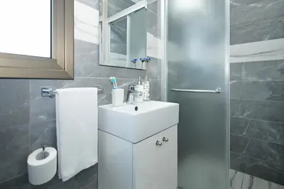 a bathroom with a sink and a mirror at Villa Maris in Protaras
