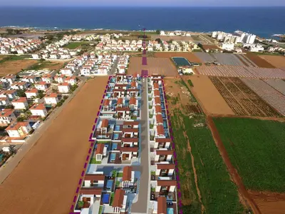 an aerial view of a city with houses and a field at Villa Maris in Protaras