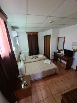a hotel room with a bed and a desk at Metropole Hotel in Limassol