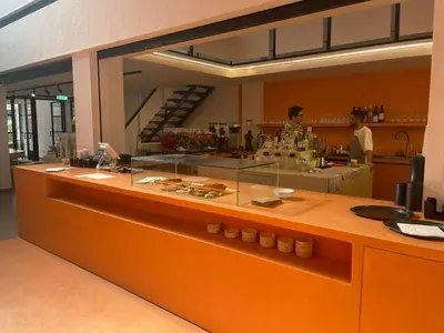 a counter in a kitchen with people in the background at Metropole Hotel in Limassol