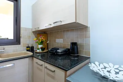 a kitchen with a sink and a counter top at Tranquil Kyklades BC6, WALK to BEACH in Paralimni
