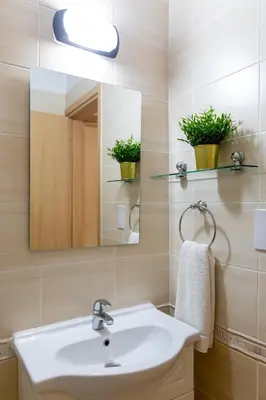 a bathroom with a sink and a mirror at Tranquil Kyklades BC6, WALK to BEACH in Paralimni